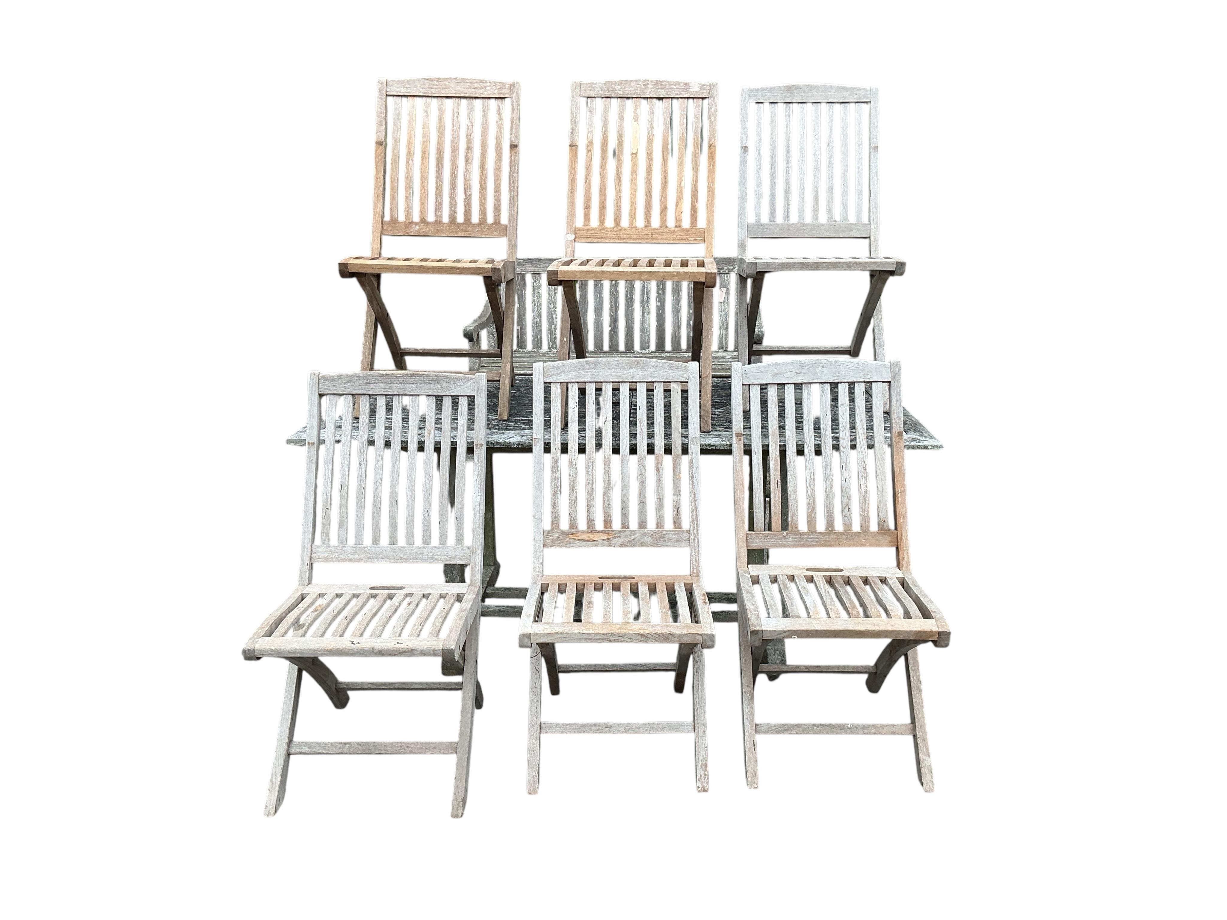 A rectangular weathered teak garden table, width 178cm, depth 90cm, height 72cm together with six Lindsey teak folding garden chairs